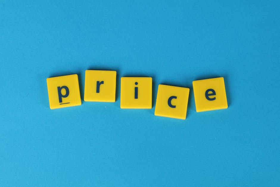 On a light blue background, five yellow plastic letter blocks are arranged in a slightly curved line to spell the word 'price.' Each block has a black lowercase letter printed on its surface, with the blocks positioned in a way that some are slightly tilted or leaning. The blocks are smooth with rounded edges and a matte finish. The overall scene is clean and minimalistic, with the focus on the bright yellow blocks contrasting against the vibrant blue backdrop. This visual can be associated with discussions of costs or pricing for rubbish removal services, subtly supporting the context of a detailed waste management price guide as offered by Rubbish Clearance Roehampton in an environmentally neutral and professional manner.